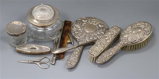 Eight silver mounted dressing table items.